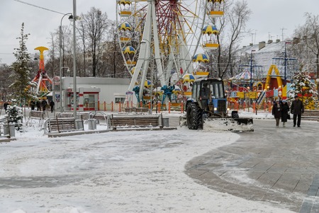 Tyumen, Russia - November 29, 2008: Tractor with snowplowing equipment cleans street in snowstorm weatherのeditorial素材