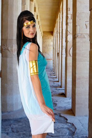 Pretty woman in egyptian queen costume near colonnade of Birth in Deir El-Bahri Temple of Queen Hatshepsutの写真素材