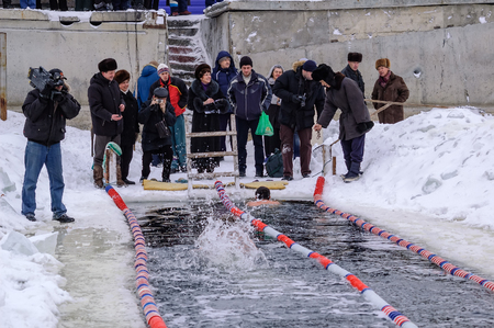 Tyumen, Russia - February 5, 2005: The club of winter swimming holds competitions in the 25 meters ice-hole. Men swimのeditorial素材