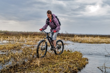 Bicycle tourist goes along the road floodedのeditorial素材