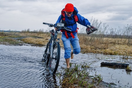 Bicycle tourist goes along the road floodedのeditorial素材