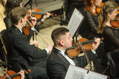 Tyumen, Russia - January 25, 2017: Concert of orchestra of the Tyumen philharmonic hall for photographers. The violin group playsのeditorial素材