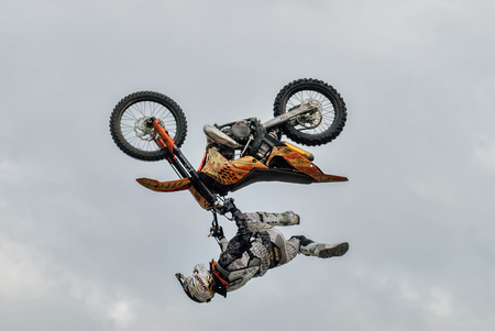 Tyumen, Russia - June 10, 2009: Stunt rider from the X-fighter team pulls upside down stunt for the watching publicのeditorial素材