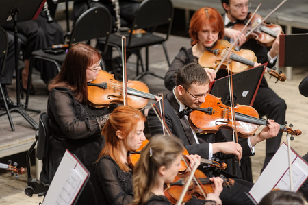 Tyumen, Russia - January 25, 2017: Concert of orchestra of the Tyumen philharmonic hall for photographers. The violin group playsのeditorial素材