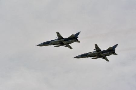Tyumen, Russia - June 23, 2017: Army Games. Engineering Formula contest. Highest military and engineering school ground. Sukhoi Su-24 russian supersonic front-line bombers in the skyのeditorial素材
