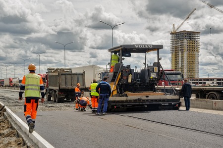 Tyumen, Russia - June 1, 2017: JSC Mostostroy-11. Construction of two-level outcome on bypass road...