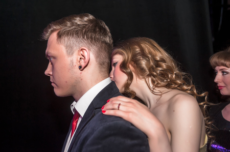 Tyumen, Russia - April 16, 2014: Competition of young performers the Song knows no limit in dramatic theater. Young couple watch performance of colleagues from the scenesのeditorial素材