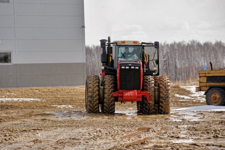 Tyumen, Russia - April 04. 2014: IV Agricultural Machinery and Equipment Tyumen specialized exhibition. Test-drive of tractor on special dirt rangeのeditorial素材