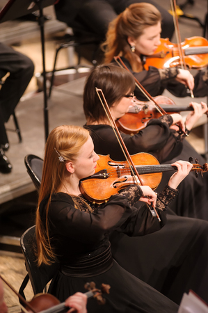 Tyumen, Russia - January 25, 2017: Concert of orchestra of the Tyumen philharmonic hall for photographers. The violin group playsのeditorial素材