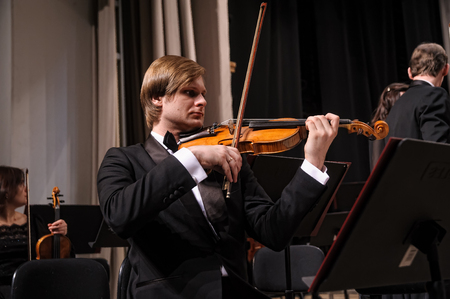 Tyumen, Russia - January 25, 2017: Concert of orchestra of the Tyumen philharmonic hall for photographers. The violin group playsのeditorial素材