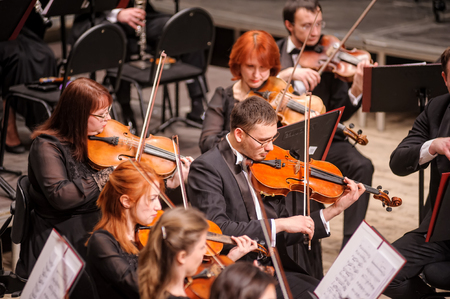 Tyumen, Russia - January 25, 2017: Concert of orchestra of the Tyumen philharmonic hall for photographers. The violin group playsのeditorial素材