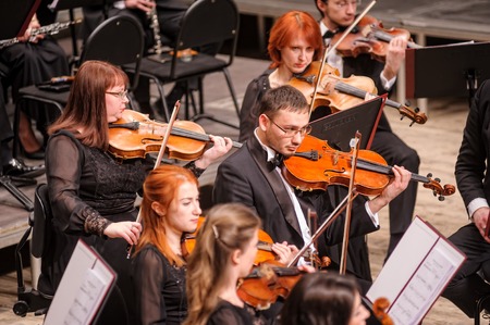 Tyumen, Russia - January 25, 2017: Concert of orchestra of the Tyumen philharmonic hall for photographers. Violin group playsのeditorial素材