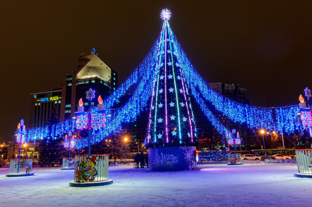 Tyumen, Russia - December 28, 2017: Christmas tree, illuminations and decorations near science and technology park. Long exposureのeditorial素材