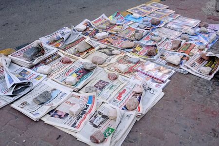 Hurghada, Egypt - November 5, 2006: Newspaper on floor for sale for sale, downtownのeditorial素材