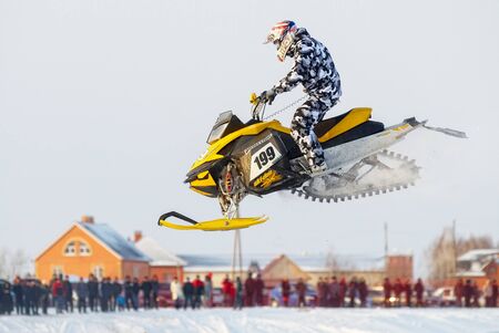 Tyumen, Russia - December 26. 2009: Sport snowmobile racing on championship of Ural region. Sportsman on snowmobile on trackのeditorial素材