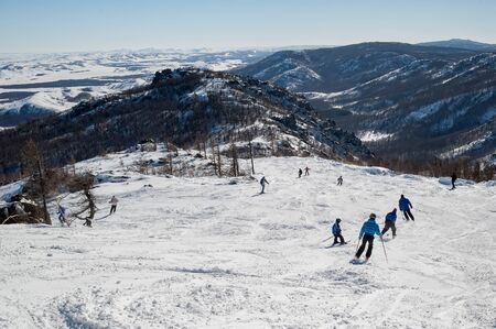 Abzakovo, Russia - March 7, 2005: Skiers skiing downhill in high mountains on a winter resortのeditorial素材