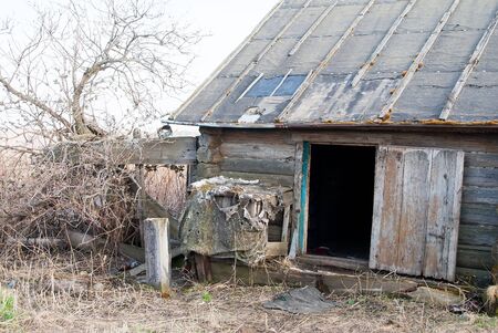 Preobrazhenka, Russia - May 2, 2010: Wooden abandoned old house with the driven-in windows. Tyumen regionのeditorial素材