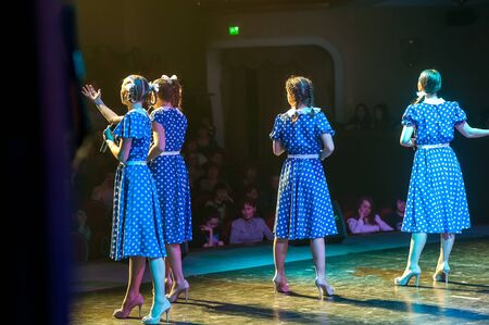Tyumen, Russia - April 16, 2014: Competition of young performers the Song knows no limit in dramatic theater. Four beautiful female singers singing a song on stageのeditorial素材