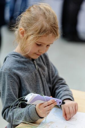 Tyumen, Russia - February 16. 2017: Open championship of professional skill among youth World skills Russia Tyumen - 2017. A young beautiful girl is experimenting with a 3D penのeditorial素材