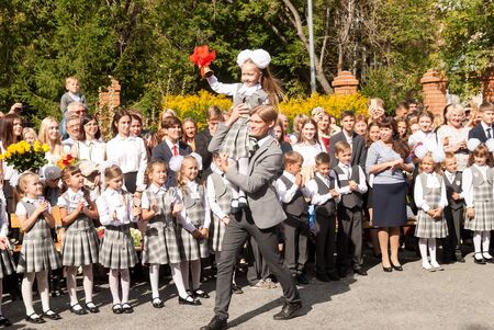 Tyumen, Russia - September 1, 2017: Gymnasium number 5. Older boy, teenager, caucasian, carries...