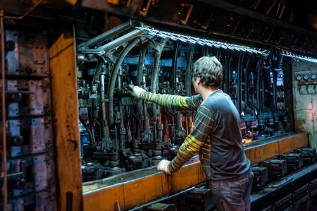 Bogandinskiy, Russia - April 20, 2018: Stekloteh factory on bottles production. Worker controls...