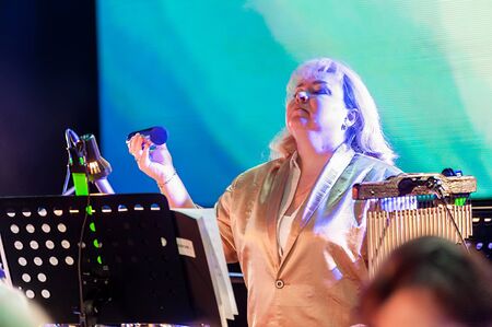 Tyumen, Russia - April 16, 2014: Competition of young performers the Song knows no limit in dramatic theater. Orchestra with musical instruments. Woman plays on xylophone and tambourineのeditorial素材