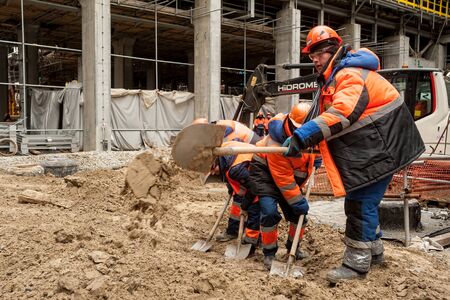 Tobolsk, Russia - May 29. 2018: Sibur company. Construction of plant on processing of hydrocarbons. Workers with a shovelのeditorial素材