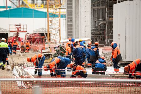 Tobolsk, Russia - May 29. 2018: Sibur company. Construction of plant on processing of hydrocarbons. Workers making foundationのeditorial素材