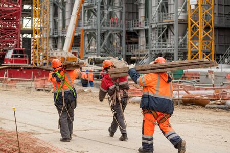 Tobolsk, Russia - May 29. 2018: Sibur company. Construction of plant on processing of hydrocarbonic raw materials. Workers bear building material on chemical plantのeditorial素材