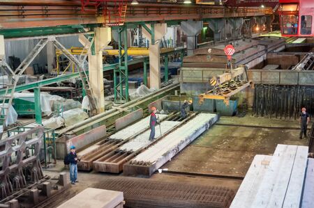 Tyumen, Russia - August 13, 2013: Block making department at construction material factory ZHBI-5. Workers in shop on production of steel concrete panelsのeditorial素材