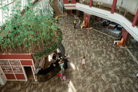 Turkler, Turkey - July 28, 2018: Lobby of Senza hotel. Family Checking In At Hotel Receptionのeditorial素材