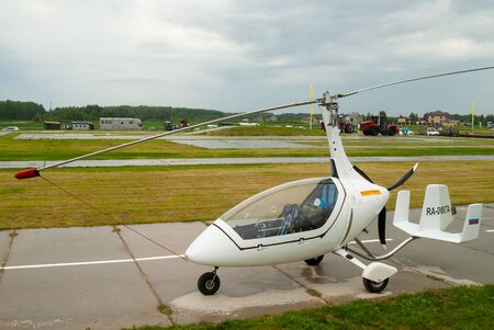 Tyumen, Russia - June 24, 2016: The 5th open championship of Russia on a plowed land. AutoGyro Europe Calidus helicopter stands on roadのeditorial素材