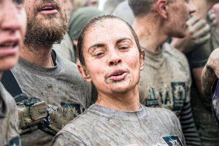 Tyumen, Russia - August 8, 2015: Steel Character command extrim race project on Krugloe lake and Gagarin park. Stage - rise on high inclined wall. Pretty girl in actionのeditorial素材