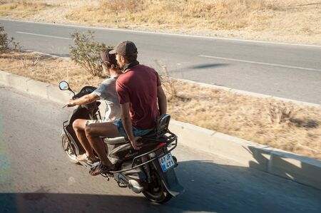 Antalya, Turkey - July 27, 2018: Man from city riding scooter on roadのeditorial素材