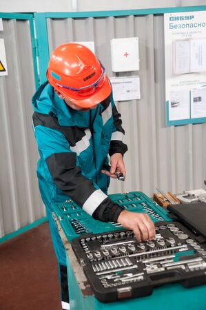 Tobolsk, Russia - July 15. 2016: Sibur company. Polymer plant. Mechanics carry out adjusting in...