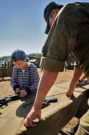 Tyumen, Russia - June 11, 2016: Race of Heroes project on the ground of the highest military and engineering school. High wall stage. Sportsman storms wallのeditorial素材