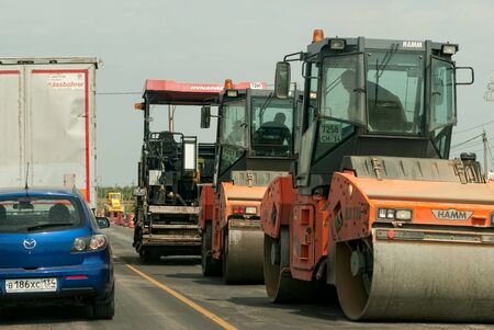 near Volgograd, Russia - July 20, 2017: Road roller and asphalt paving machine at construction siteのeditorial素材