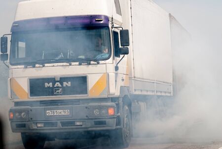 near Volgograd, Russia - July 20, 2017: Loaded European truck on motorway in smokeのeditorial素材
