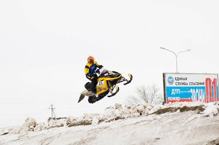 Tyumen, Russia - March 08. 2008: IV stage of personal-team Championship of Ural Federal district in over-snow cross-country. High jump of sportsman on snowmobileのeditorial素材