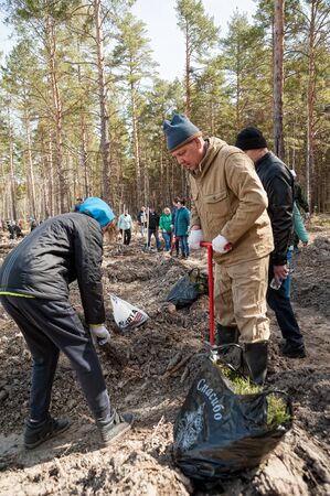 Taraskul, Russia - May 24, 2018: Action of restoration of the wood. People put saplings on the fringe of the forestのeditorial素材