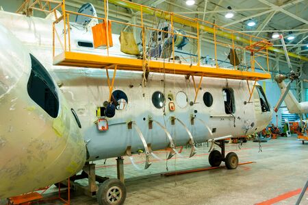Tyumen, Russia - June 5, 2019: Aircraft repair helicopter UTair Engineering plant. Mi-8 helicopter during maintencance and repair at the service hangarのeditorial素材