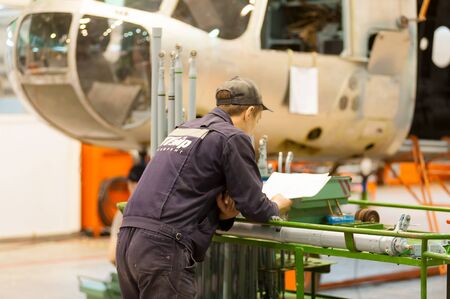 Tyumen, Russia - June 5, 2019: Aircraft repair helicopter UTair Engineering plant. Worker...