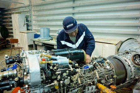 Tyumen, Russia - June 5, 2019: Aircraft repair helicopter UTair Engineering plant. Worker...
