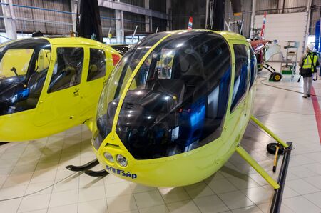 Tyumen, Russia - June 5, 2019: Aircraft repair helicopter UTair Engineering plant. Robinson R44 helicopters during maintencance and repair at the service hangarのeditorial素材