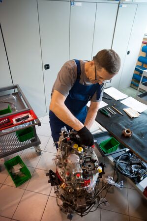 Tyumen, Russia - June 5, 2019: Aircraft repair helicopter UTair Engineering plant. Worker maintaining engine of import helicopterのeditorial素材