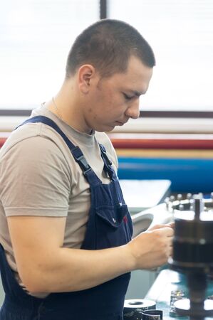 Tyumen, Russia - June 5, 2019: Aircraft repair helicopter UTair Engineering plant. Technician at machine maintenance working with wrenchのeditorial素材