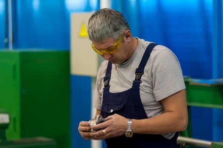 Tyumen, Russia - June 5, 2019: Aircraft repair helicopter UTair Engineering plant. Technician at machine maintenance working with wrenchのeditorial素材
