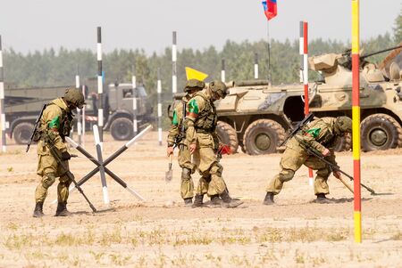 Tyumen, Russia - August 11, 2019: International Army Games. Safe Route contest. Engineers with mine detectors move and make a passのeditorial素材