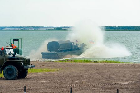 Tyumen, Russia - August 10, 2019: International Army Games. Engineering Formula contest. Equipment transportation across a water obstacle tracked amphibious carrier PTSのeditorial素材