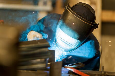 Welders in action with bright sparksの写真素材